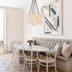 Exuding modern mid-century charm, this chic cluster chandelier effortlessly enhances any interior space with its stylish design. Crafted with a harmonious fusion of metal and opal globes, it creates a captivating visual display while illuminating the room from multiple angles. The opal glass shades, paired with 13 E26/E27 bulbs (bulbs not included), cast a warm and inviting glow throughout, perfect for creating a welcoming ambiance.