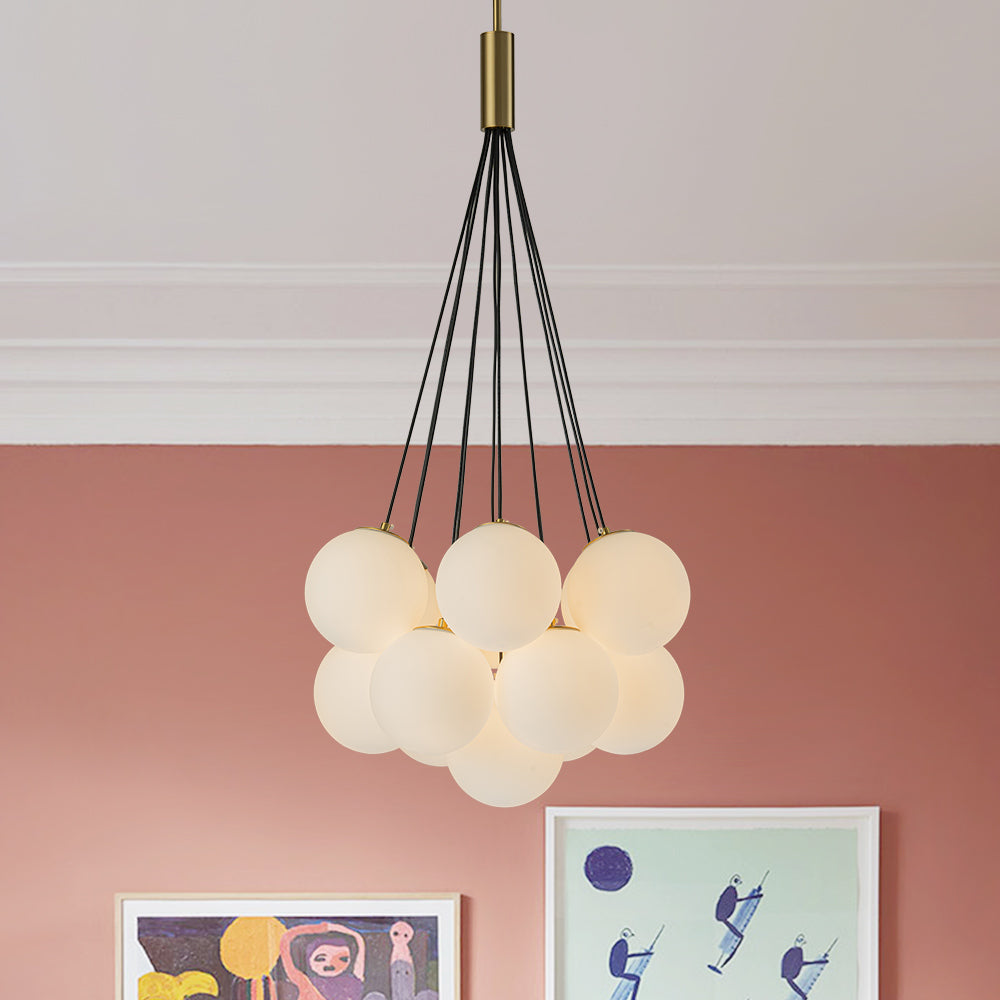 Exuding modern mid-century charm, this chic cluster chandelier effortlessly enhances any interior space with its stylish design. Crafted with a harmonious fusion of metal and opal globes, it creates a captivating visual display while illuminating the room from multiple angles. The opal glass shades, paired with 13 E26/E27 bulbs (bulbs not included), cast a warm and inviting glow throughout, perfect for creating a welcoming ambiance.