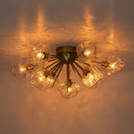 Introducing our 9-Light Modern Glam Ice Glass Semi Flush Mount Ceiling Light, designed to transform your dining room, kitchen, or living room into a space of unmatched elegance. This fixture boasts a metal hemisphere, expertly crafted with nine lamp arms and ornate stems, culminating in a captivating sunburst silhouette.